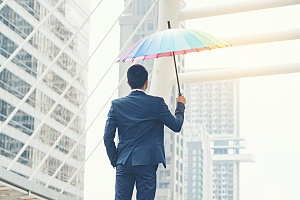 man holding an umbrella who is covered by umbrella insurance