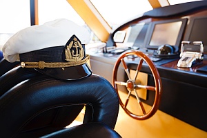 Captain hat sitting by steering wheel