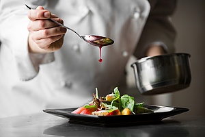 a dish being created by a chef at a fancy restaurant