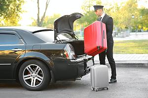 Limo driver loading trunk
