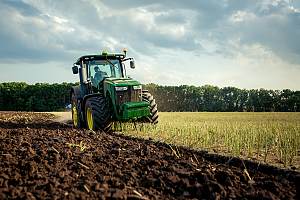 Tractor plowing field on a farm