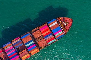 cargo ship carrying crates across the ocean