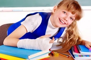 school girl with injured arm in school