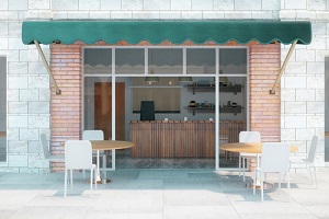 cafe with brick walls and green canopy exterior design