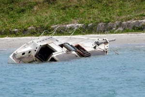 damaged boat near seashore