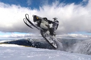 man jumping with snowmobile