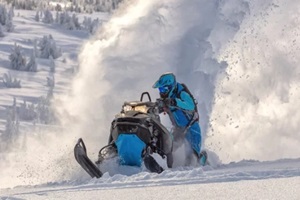 rider performing stunt with snowmobile