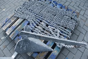anchor and chain from a sailing yacht or boat laid out on the ground of a boatyard for the winter