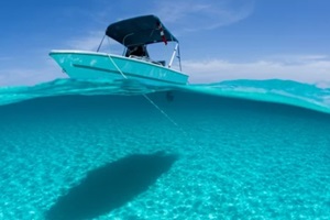 boat is anchored in the clear blue tropical waters