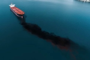ecological disaster, oil spill in ocean near tanker, top view