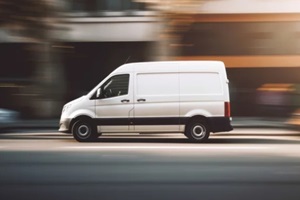 white delivery van side view on blur city street background