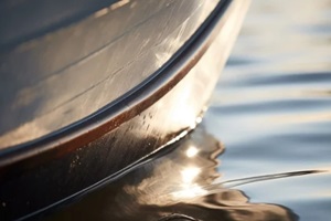 close-up of a sailboat hull merging with the waterline in the sea