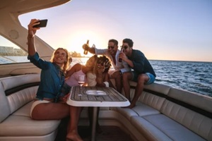 group of people taking selfie at boat party