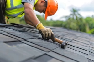 roofer worker in special protective work wear and gloves