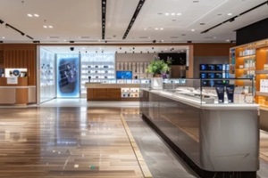 contemporary retail space showcasing products on a central display podium with illuminated shelves lining the walls